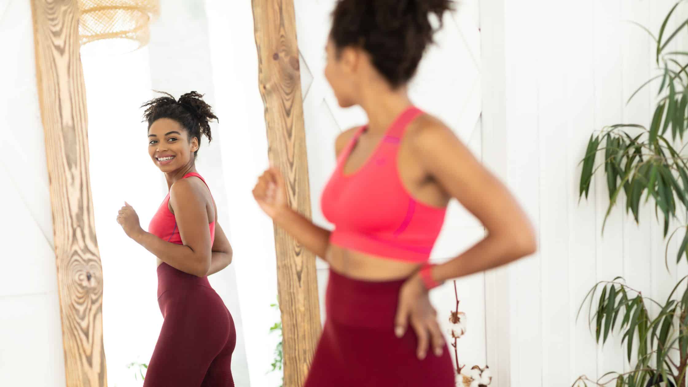 happy woman looking in the mirror